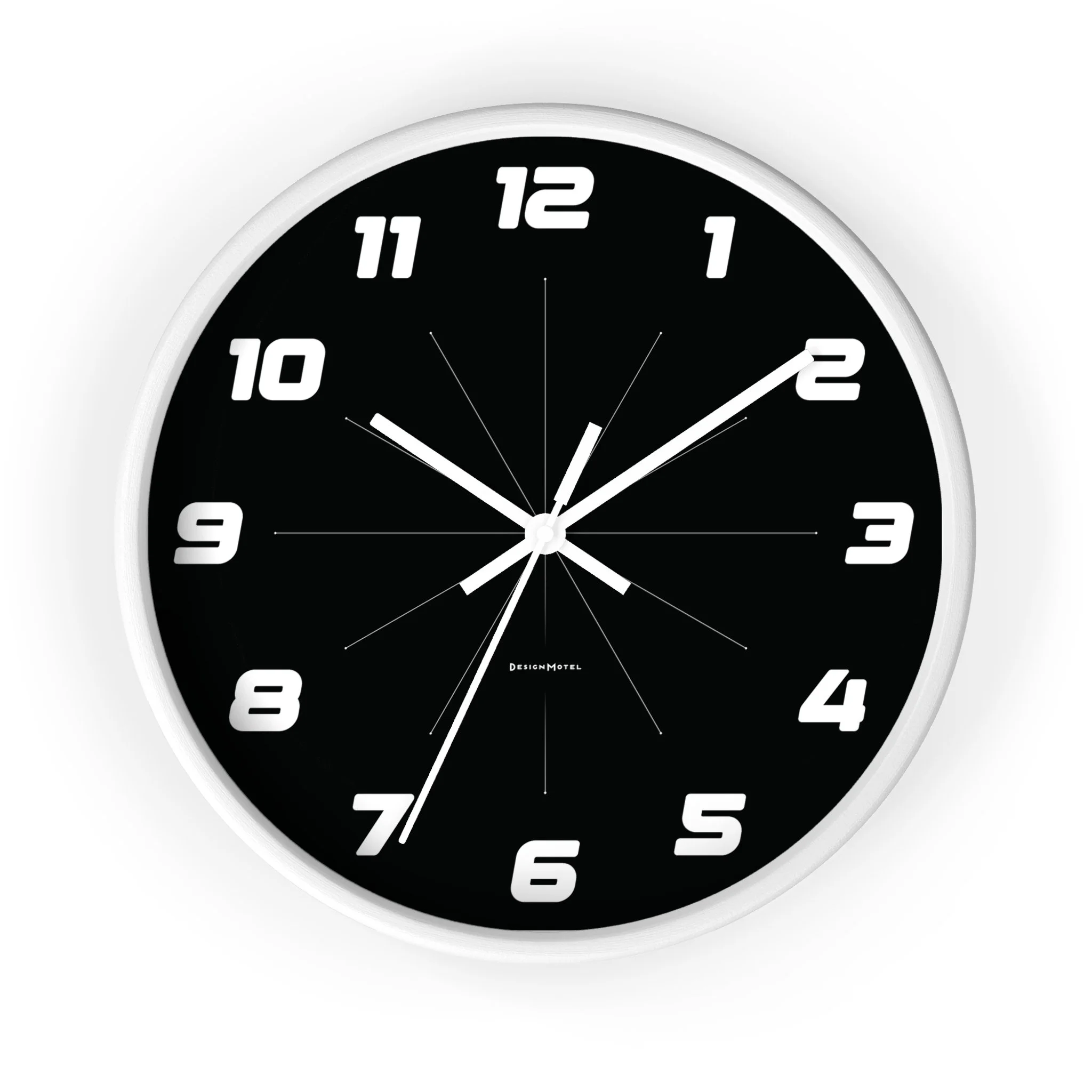 Black wall clock with white numbers and silver frame, showing the time approximately 10:10:37.