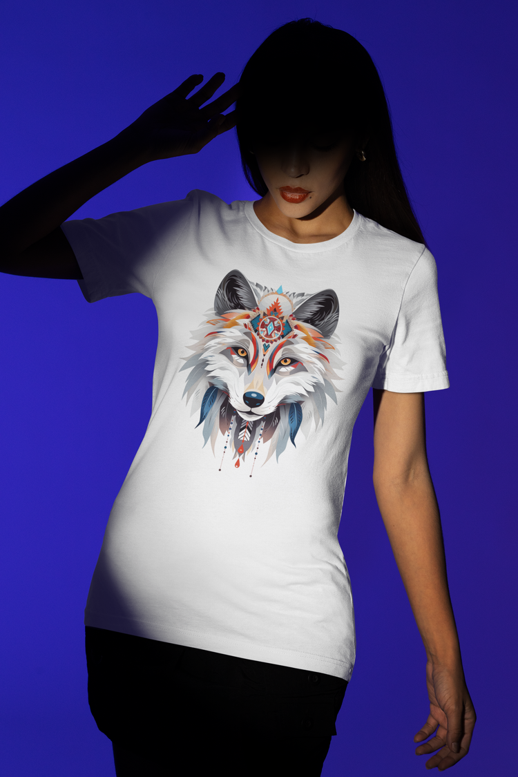 Animal spirit shirt featuring a stylized arctic fox head on a white T-shirt, worn my a young woman on a purple background. She is in shadow except for a spotlight on the shirt and her torso.