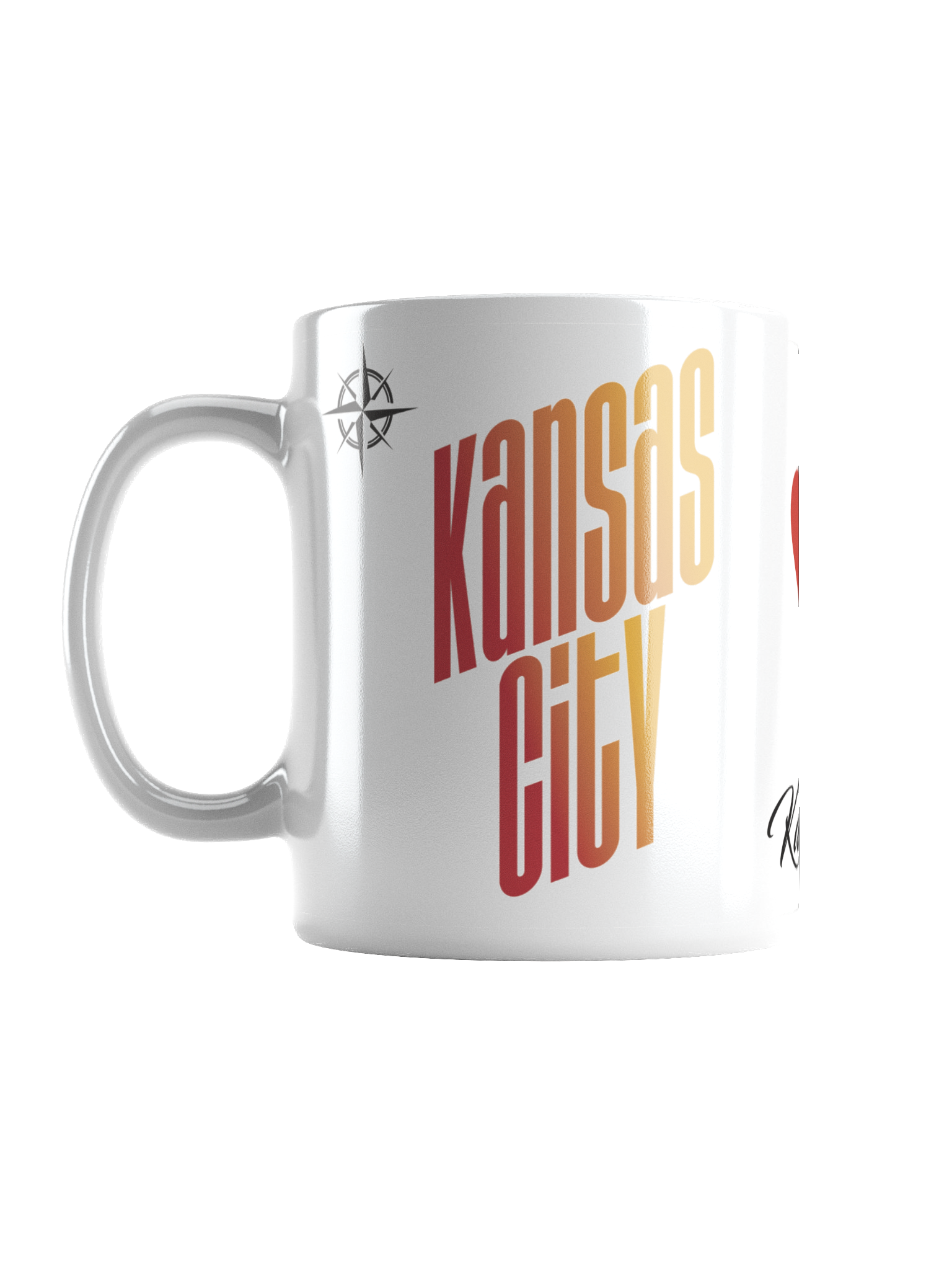 A white ceramic mug with a colorful, stylized text design that reads 'Kansas City' in large, bold, stacked letters in red and orange gradients. The mug also features a small compass symbol near the handle.