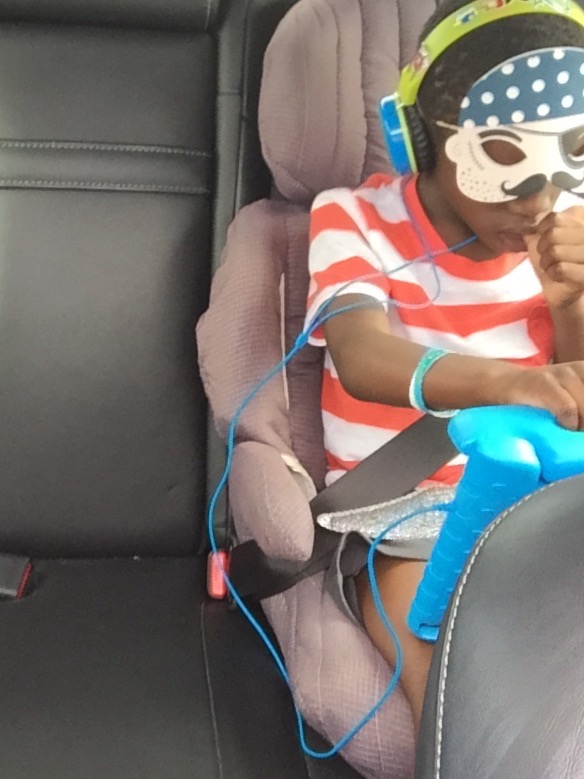 Tisetso enjoying being a pirate and watching Harry Potter/Ben 10 while driving home.