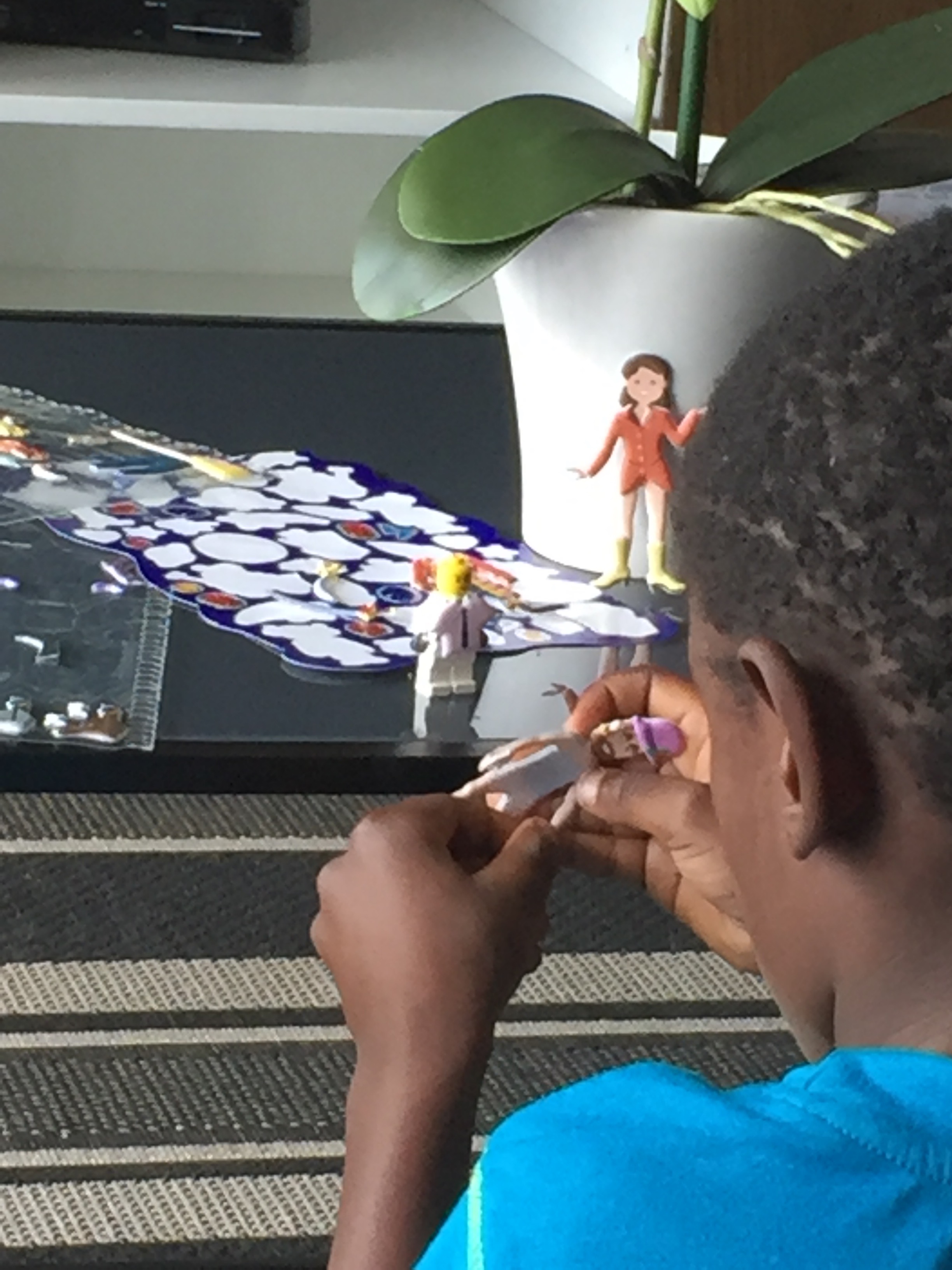 Tisetso playing with his reusable stickers. I loved how he had stuck a shirt on the Lego man and put a pink flower hat on his pirate.