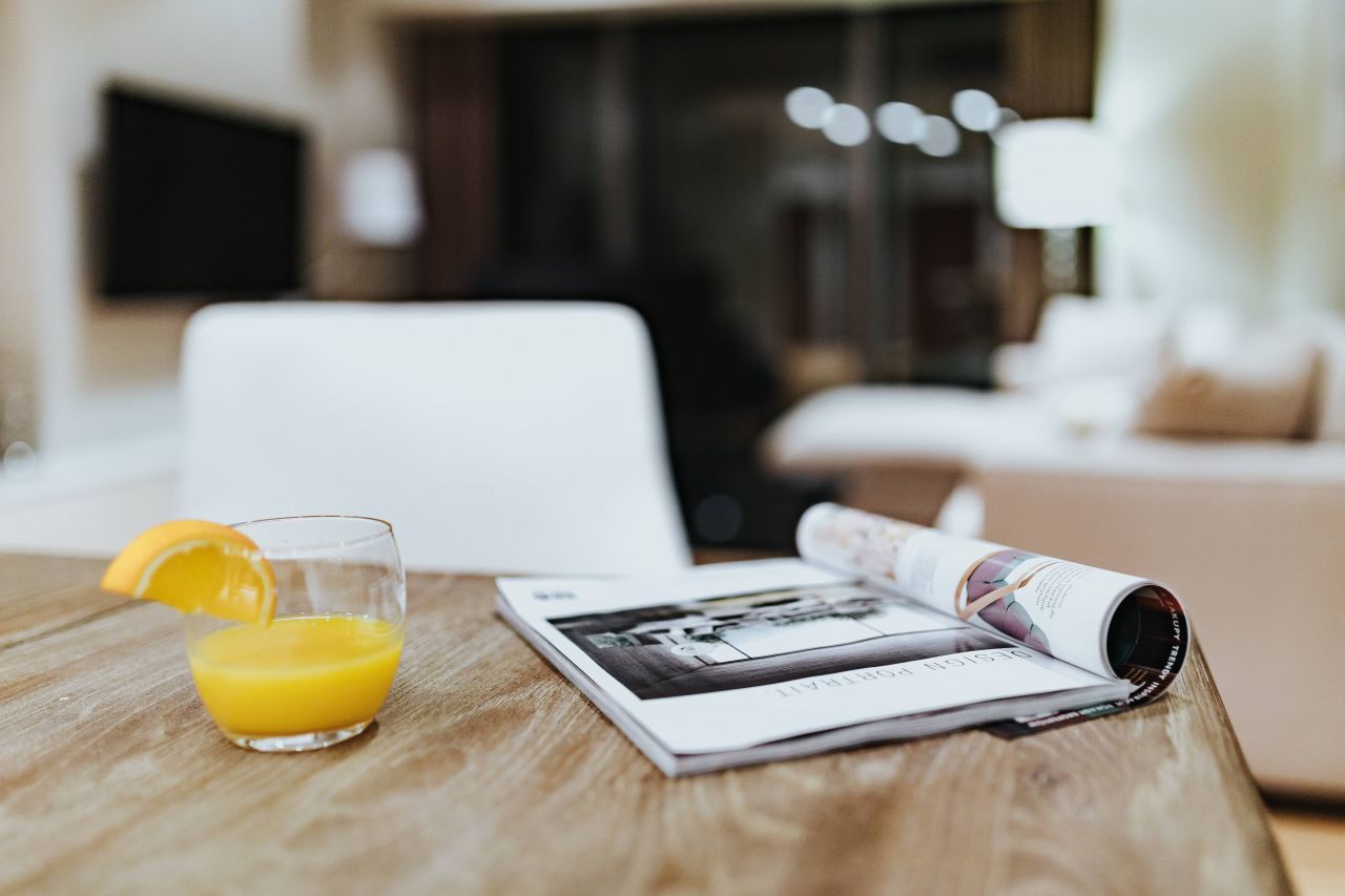 kaboompics_Magazine with a fresh juice on a table.jpg