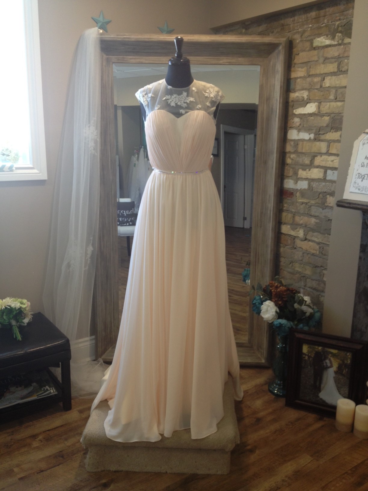 This flowy chiffon gown is perfect for a summer wedding. With just a touch of lace & adding a touch of sparkle, you combine comfort with elegance. This gown is sold exclusively at Once Upon A Time Weddings.