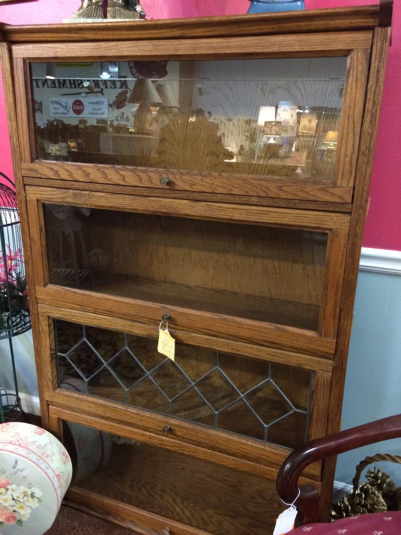I'm a sucker for barrister bookcases, and this one was reasonably priced compared to others I've seen. It may not be quite as 'antique' but it still had the look and feel of that style bookcase and I'm a sucker for storage.