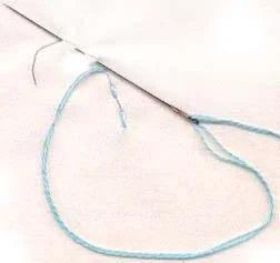 Come up at the start of the line, weave the needle in and out along the line, stacking several stitches on the needle each time.
