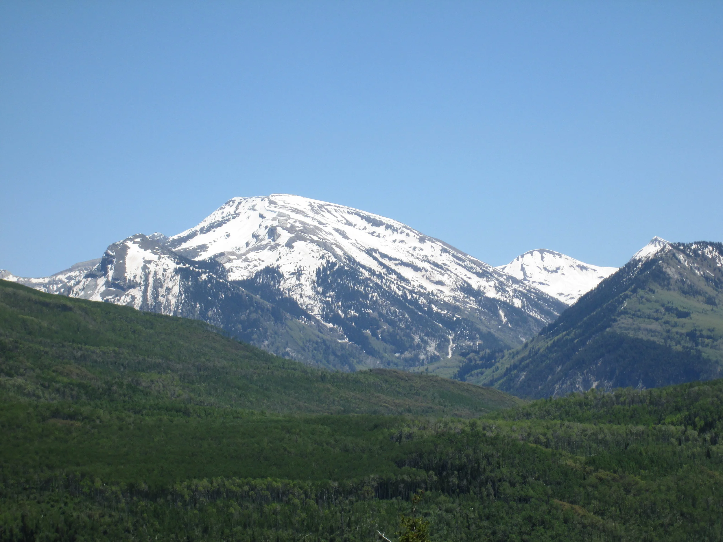 Considerable snowpack remained in alpine terrain in Yule Creek and other Crystal River headwaters, as seen from McClure Pass, and dust was rapidly emerging on even the highest north-facing slopes. 
