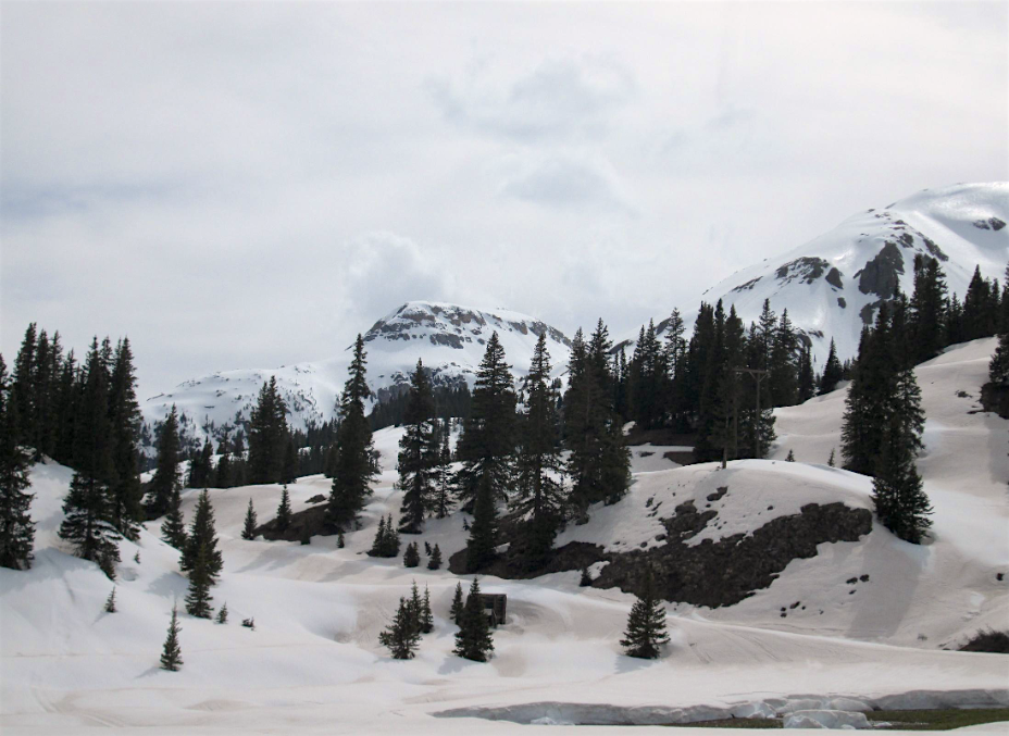 Photo taken May 20 near SASP. In the foreground the snow surface shows dust emergence. In the ba ckground dust mostly not emerged at higher elevations.