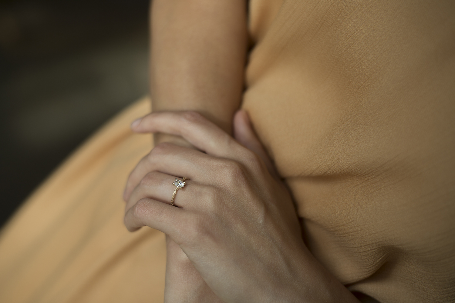 woman wearing hand carved engagement ring