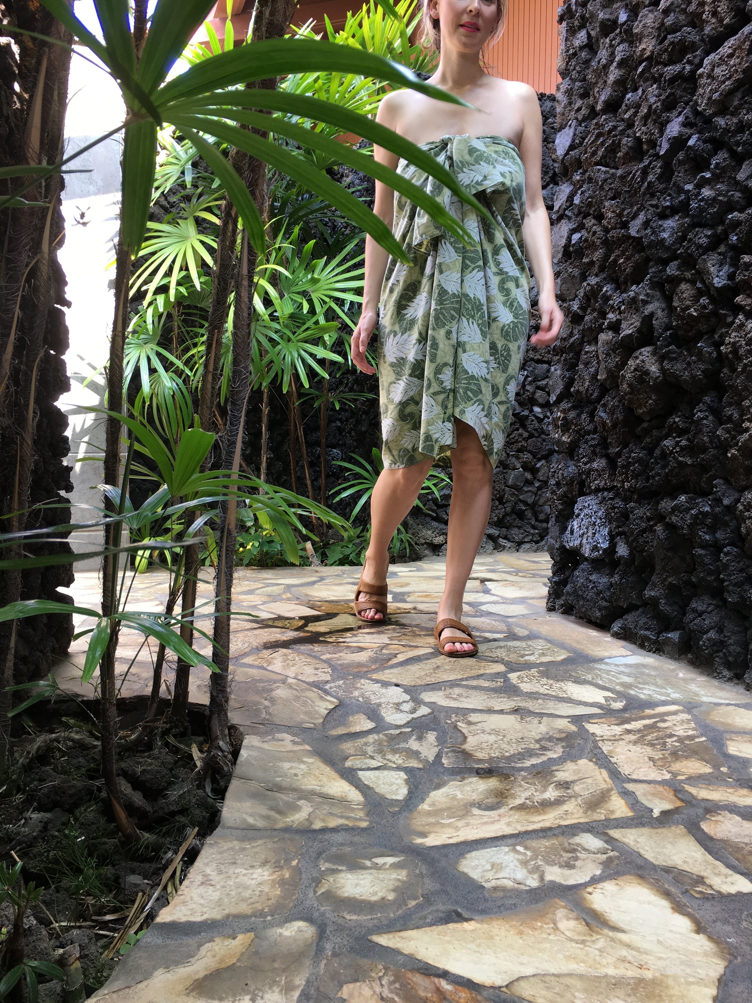 Outfitted in a traditional lava lava, I felt lighter the minute I stepped on the ancient lava flow’s grounds graced with thatched-roof huts, pools of orchids, and palms rustling in the wind.