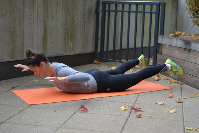 7. Superman *Start laying flat on your front. Push your pelvis into the ground as you slowly lift your upper and lower body up in unison.