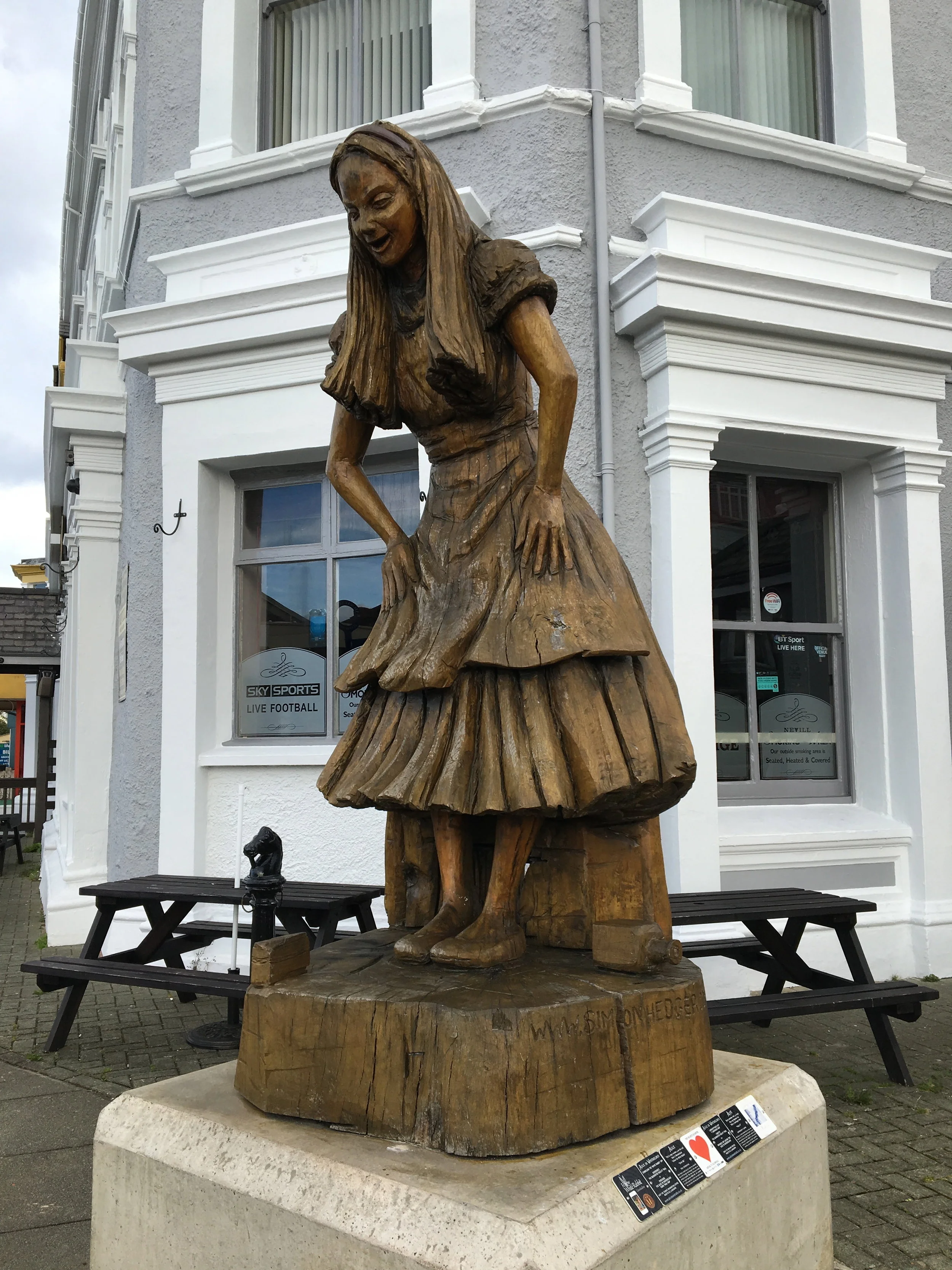 statue of Alice in Wonderland outside the Llandudno train station