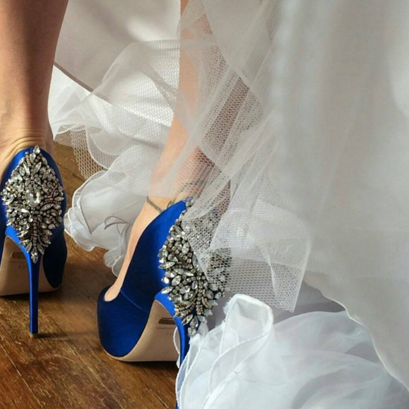 Photo of Silver Wedding Shoes with Gown in Background