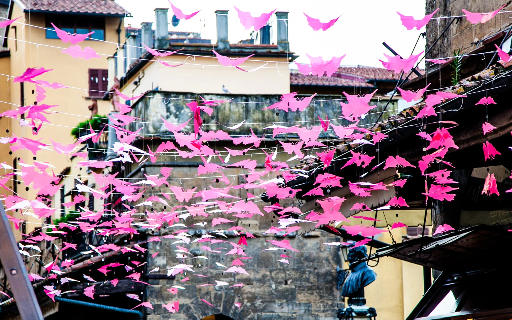 Crossing the Ponte Vecchio Bridge in Florence, the home of many high priced gold and jewelry stores..the decorations were being put up for a parade that was going to take place later in the day