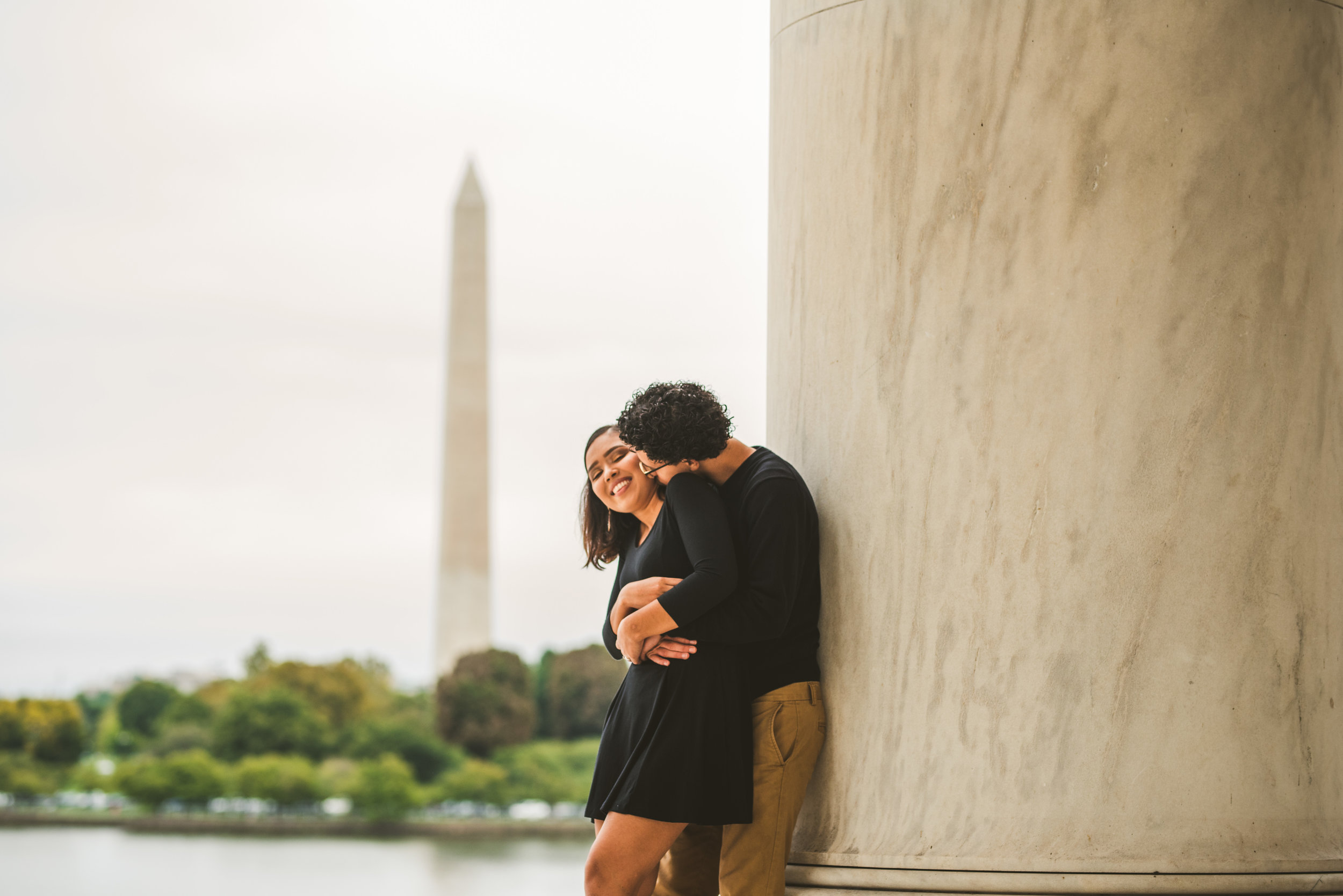 Couple hugging infront of the Washington D.C Monument in Washington D.C 