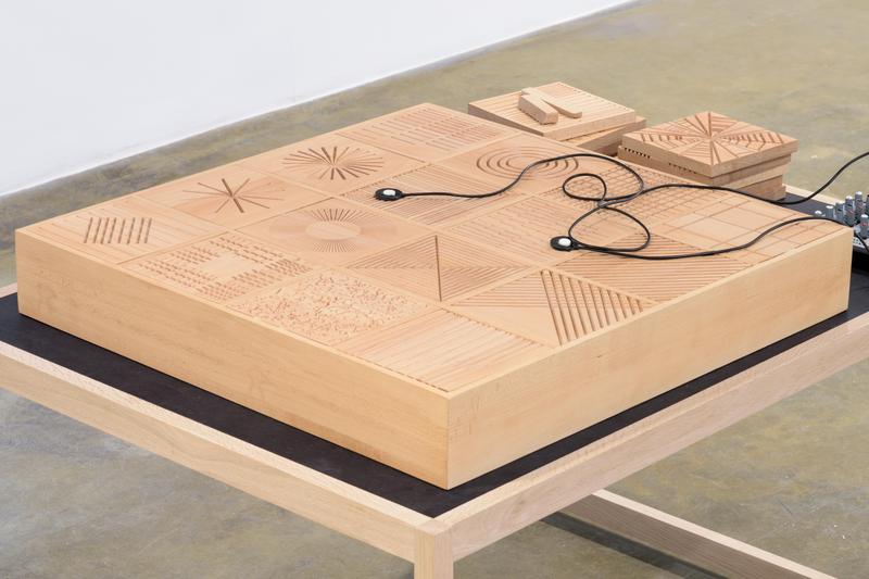 Tarek Atoui Iteration on drums #1 2016 Wooden table, 24 wooden plates, 4 contact microphones, mixing console, wooden drumsticks - Practice book, music scores, activating instructions and 15 min. sound piece by