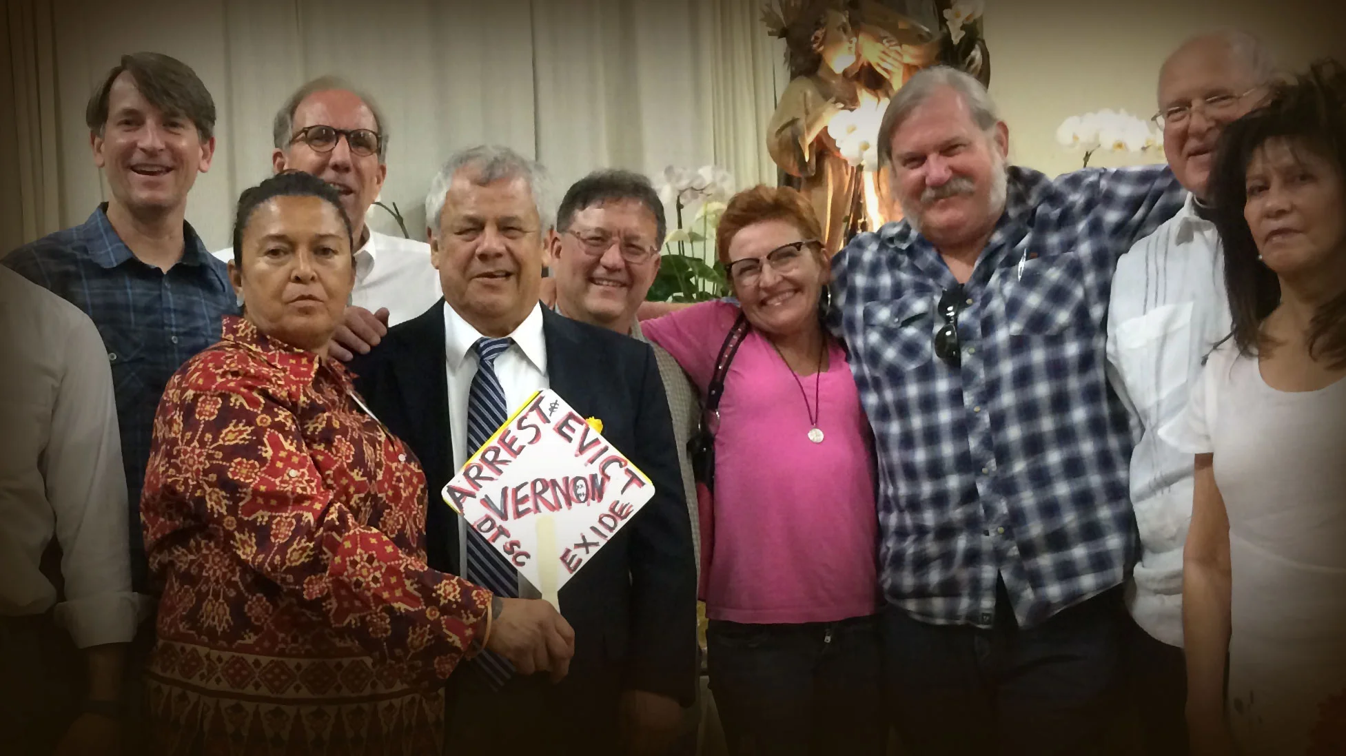 The Exide Vernon Plant Closure Team at the East L.A. Party. (left to right) Joe Johns - Asst. U.S. Atty., Unnamed Church Activist, William Carter, Unnamed Church Activist, Rick Jones - DTSC Scientist/Investigator, Annette O'Donnelly - Lead Investigator EPA CID, Paul Baranich - DTSC Scientist/Investigator, Monsignor John - Church Activist, Unnamed Church Activist.