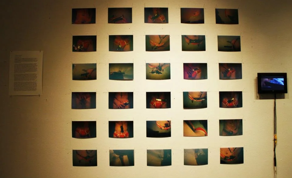 Self Portrait as Sebastian, After Jared Lee (Installation Shot) Approx. 8' x 8' Series of 4" x 6" photos, Mini LCD Screen wity looping video 2011