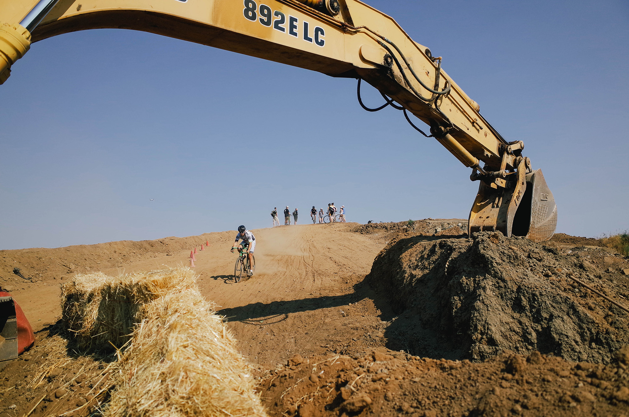 What other race has you riding under the construction equipment that built the course?