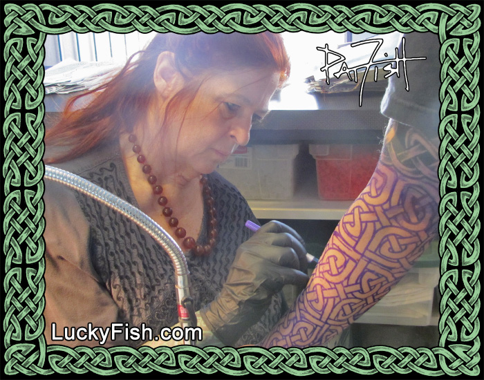 Pat Fish Adjusting a Knotwork Stencil Before Beginning to Tattoo
