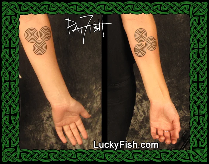 Matching Celtic triple spiral tattoo by Pat Fish