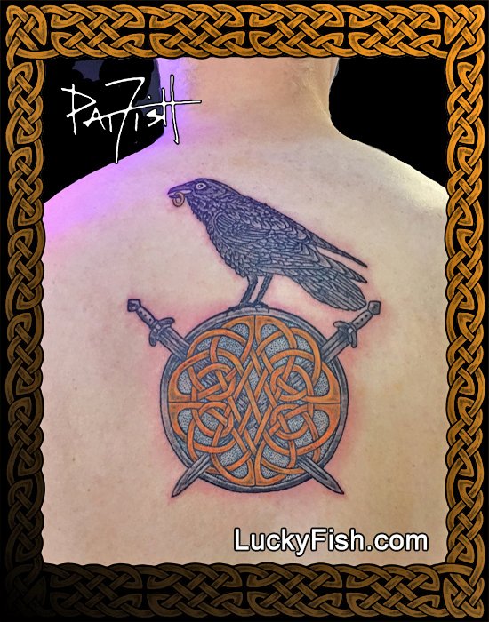 heraldic raven tattoo with celtic swords design