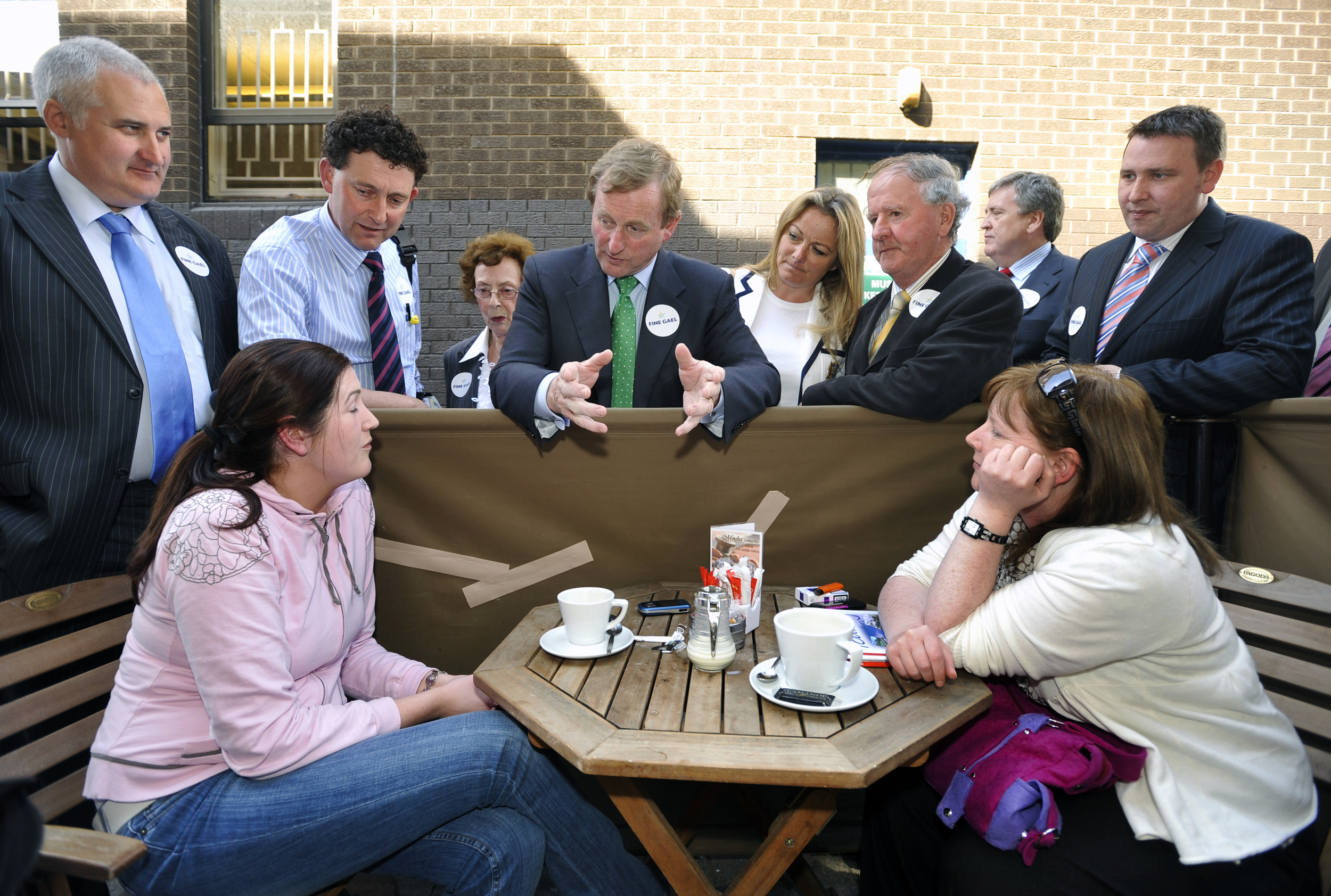Fine Gael leader Enda Kenny engages with some Al fresco diners during his visit to Ennis. Looking on are candidates Roger Fox, Johnny Flynn, Mary Coote Ryan, Mary Howard, Gabriel Keating and TD's Pat Breen and Joe Carey.