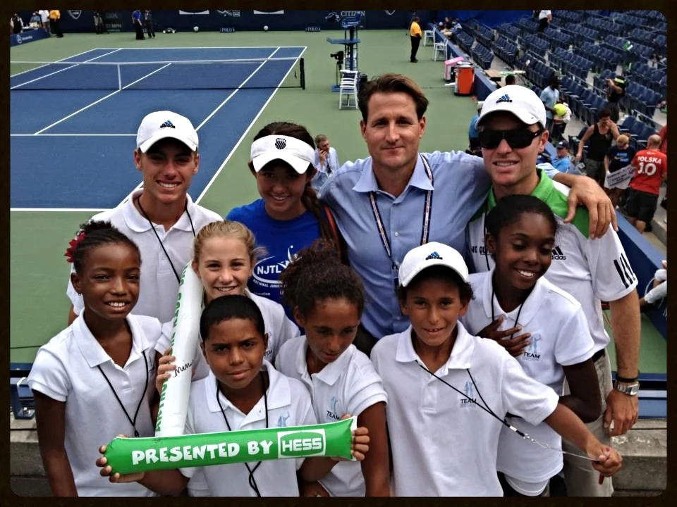Trenton Alenik in the back right with founder Ryan Wolfington and children of the Foundation.