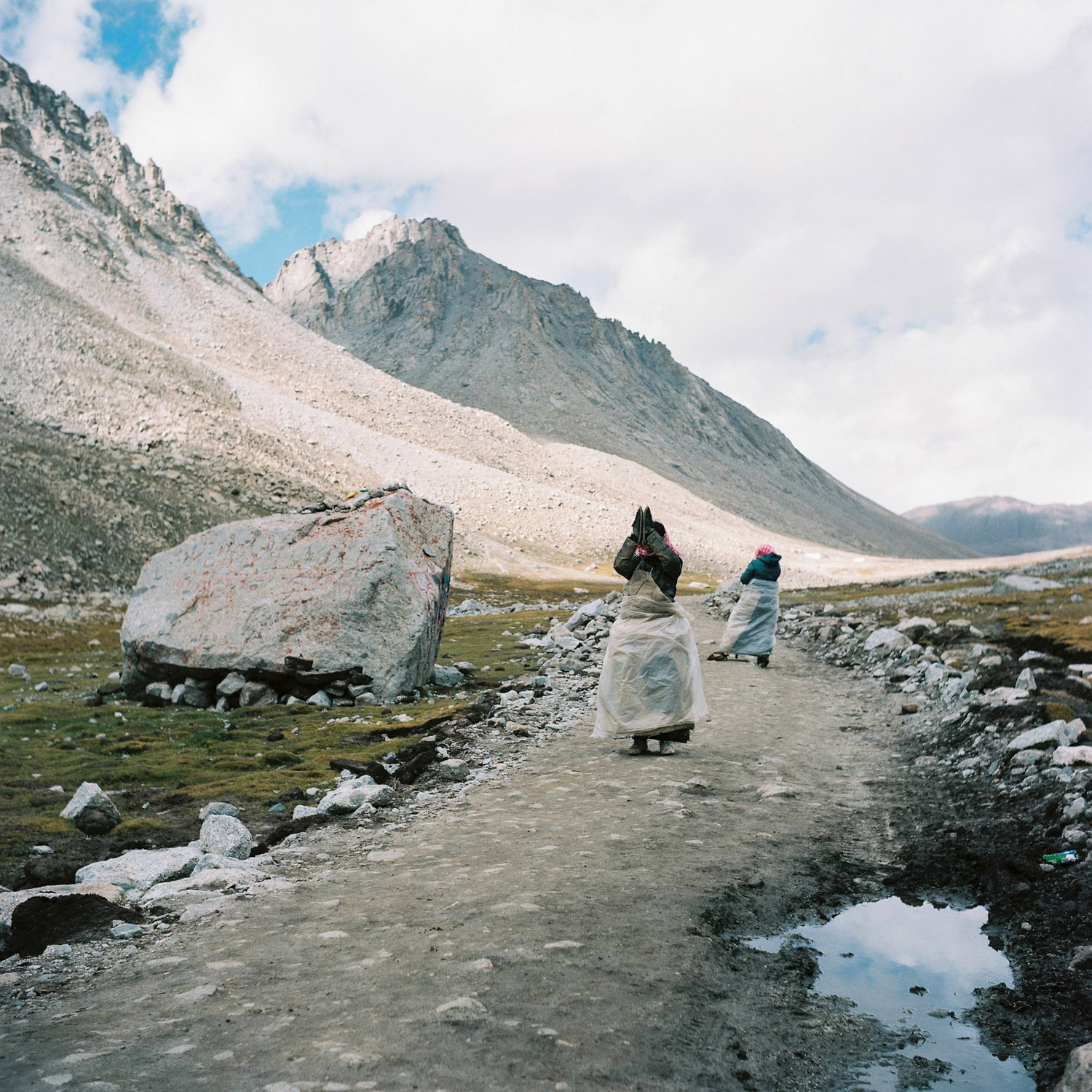 Buddhist pilgrims prostrating around Mt. Kailash.jpg