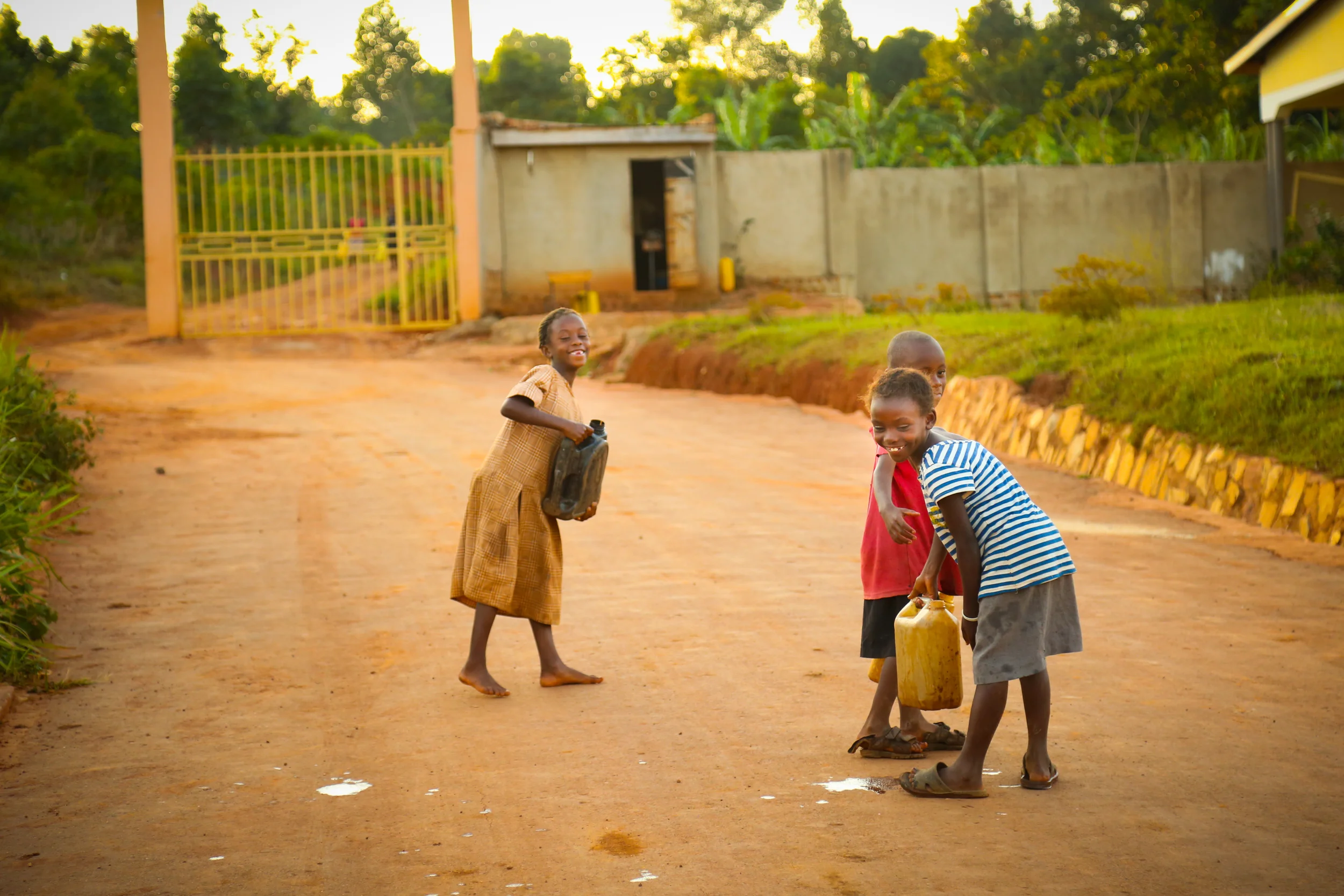 Every morning and dusk, local villagers come to a well in the school to get some water for their family at home. Then they walk back to a long steep and bumpy road to get home. Those containers filled with water were heavy. 