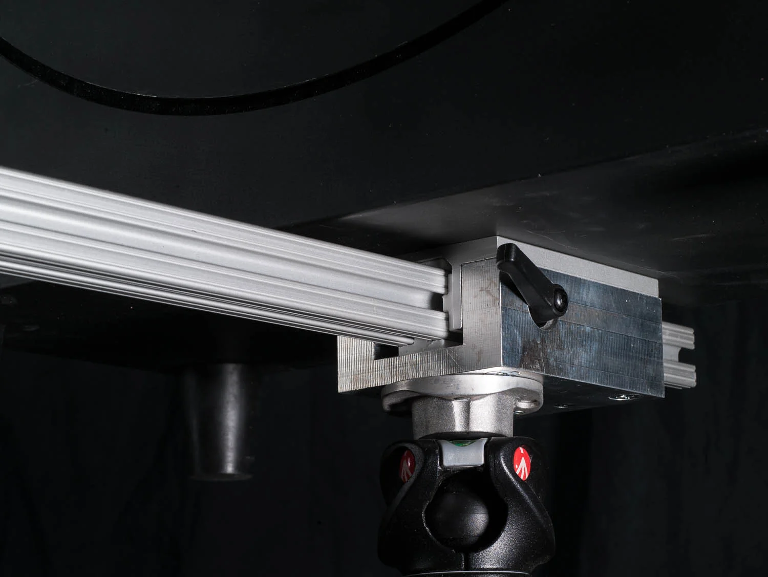 A custom mount I designed and machined that attaches the camera to the tripod and the lens rail.