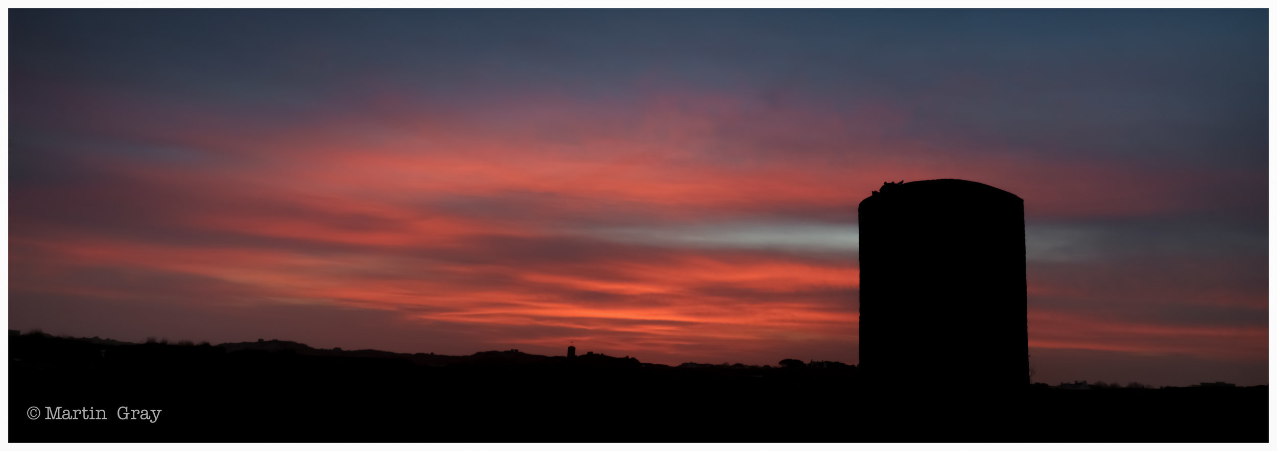 'Before the Sun'... L'Ancresse Common with a Martello Tower and red sky...