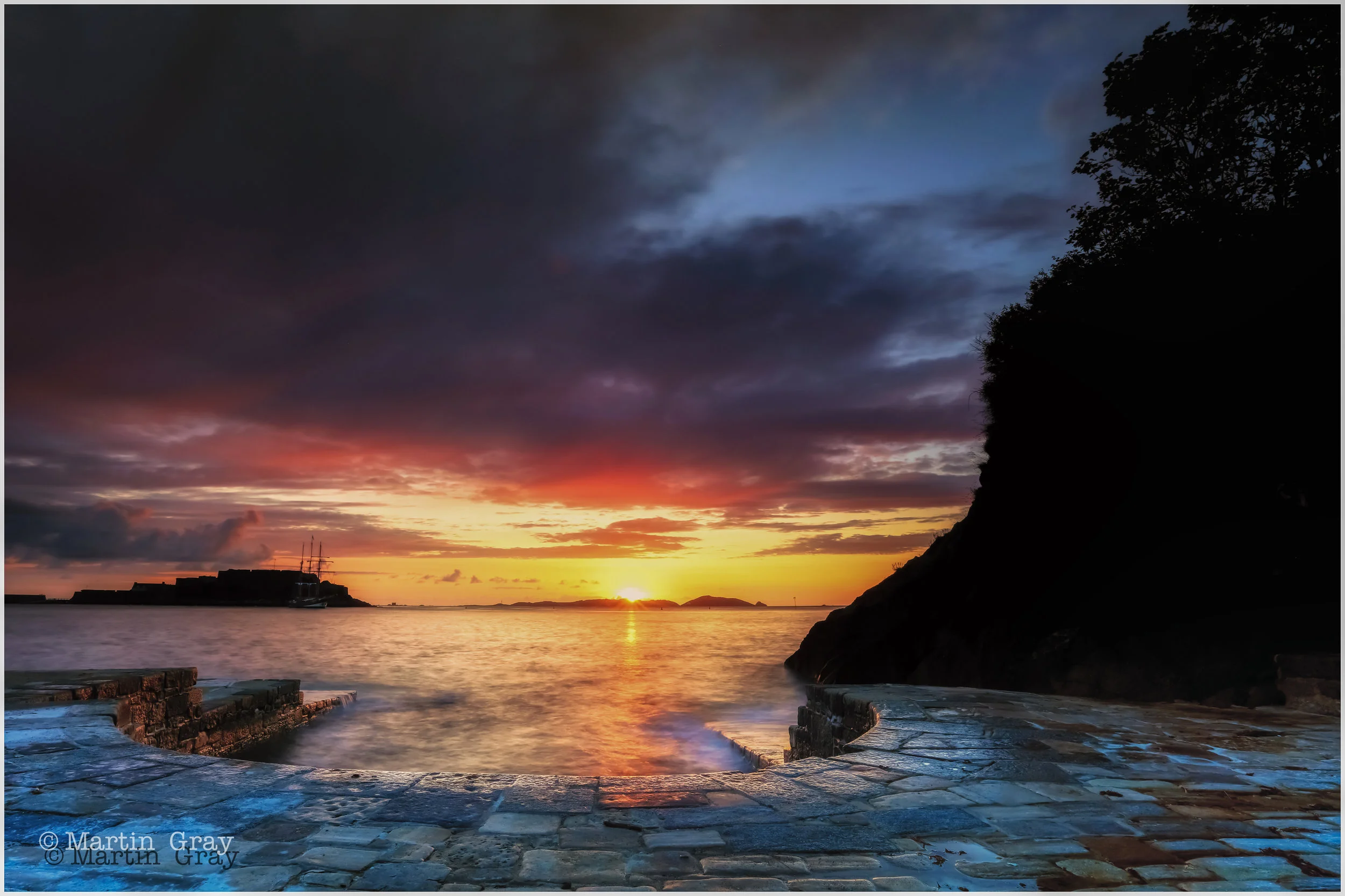 'The Horseshoe Pool'... The restored Horseshoe Pool at La Vallette at sunrise over Herm with Castle Cornet in the background...