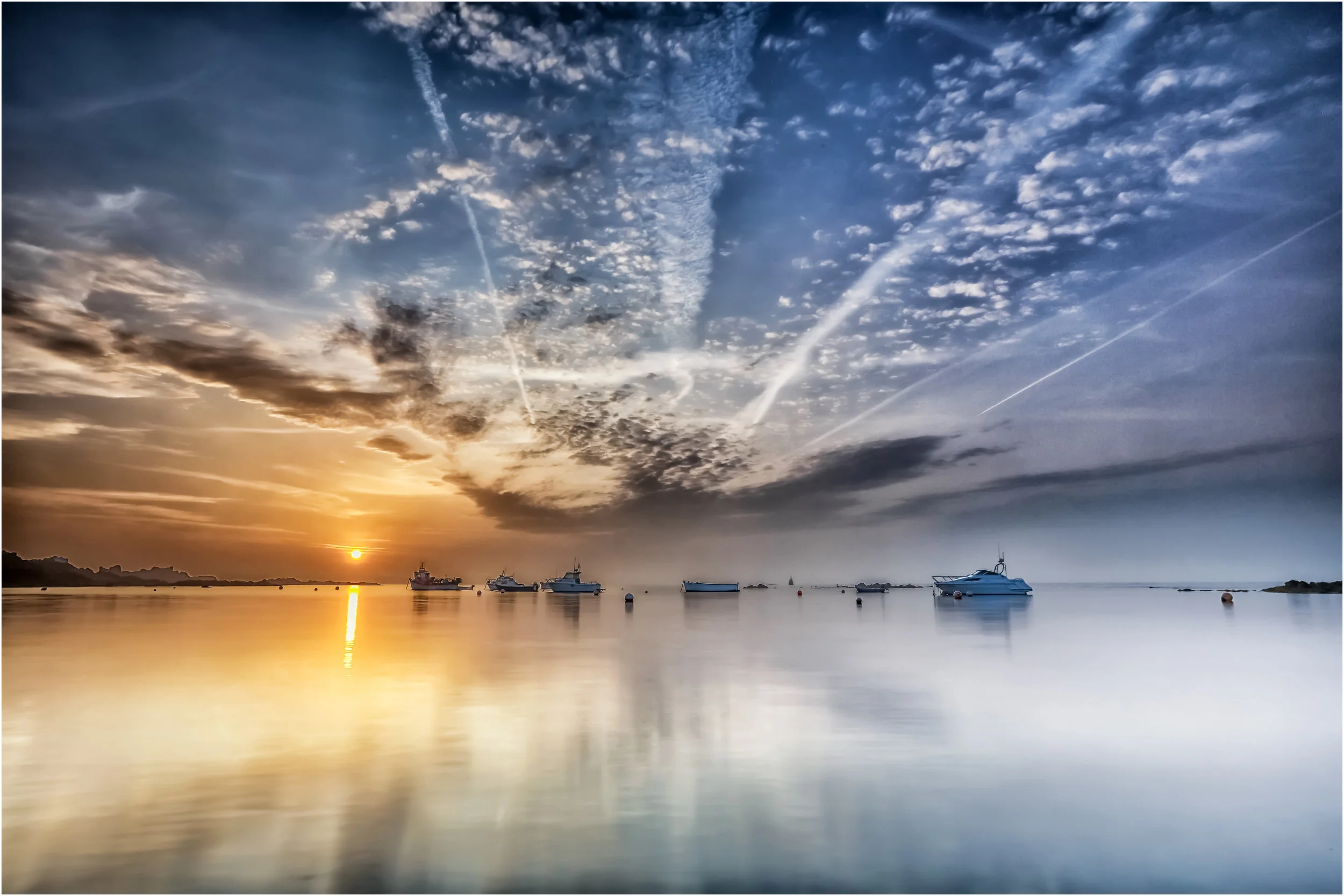 'Daybreak at the Bay'... Boats moored in the bay outside of Guernsey's Bordeaux Harbour as a misty morning clears...