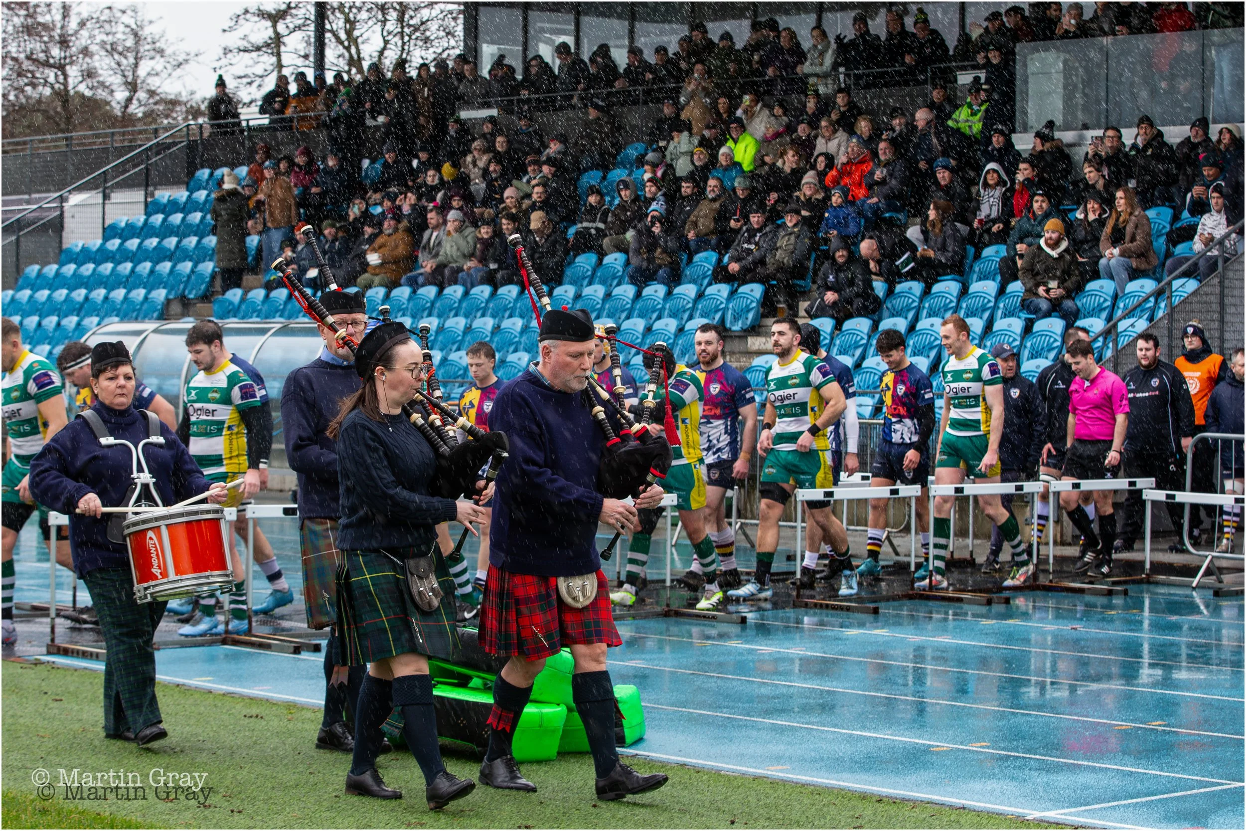 Bagpipes lead the two team onto the field-9309.jpg
