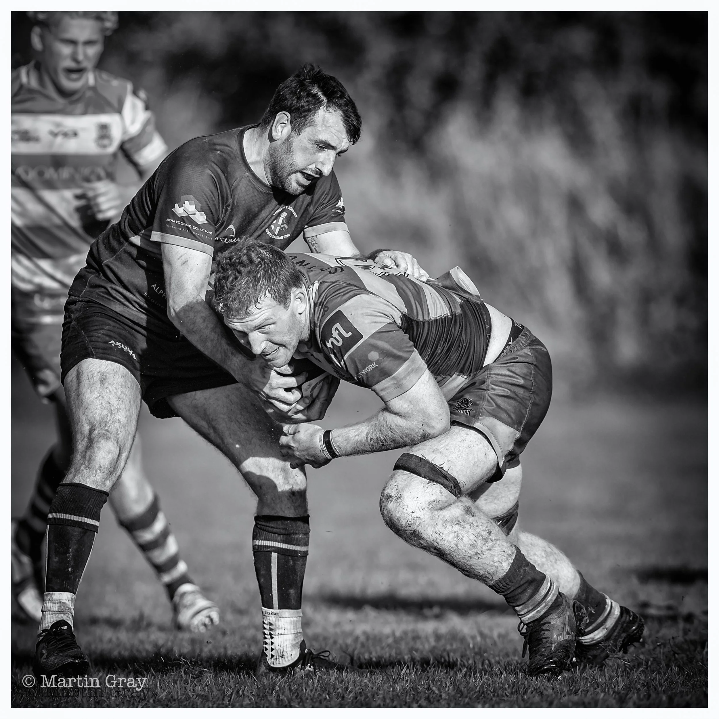 Chris Croft drives through a tackle B+W-2.jpg