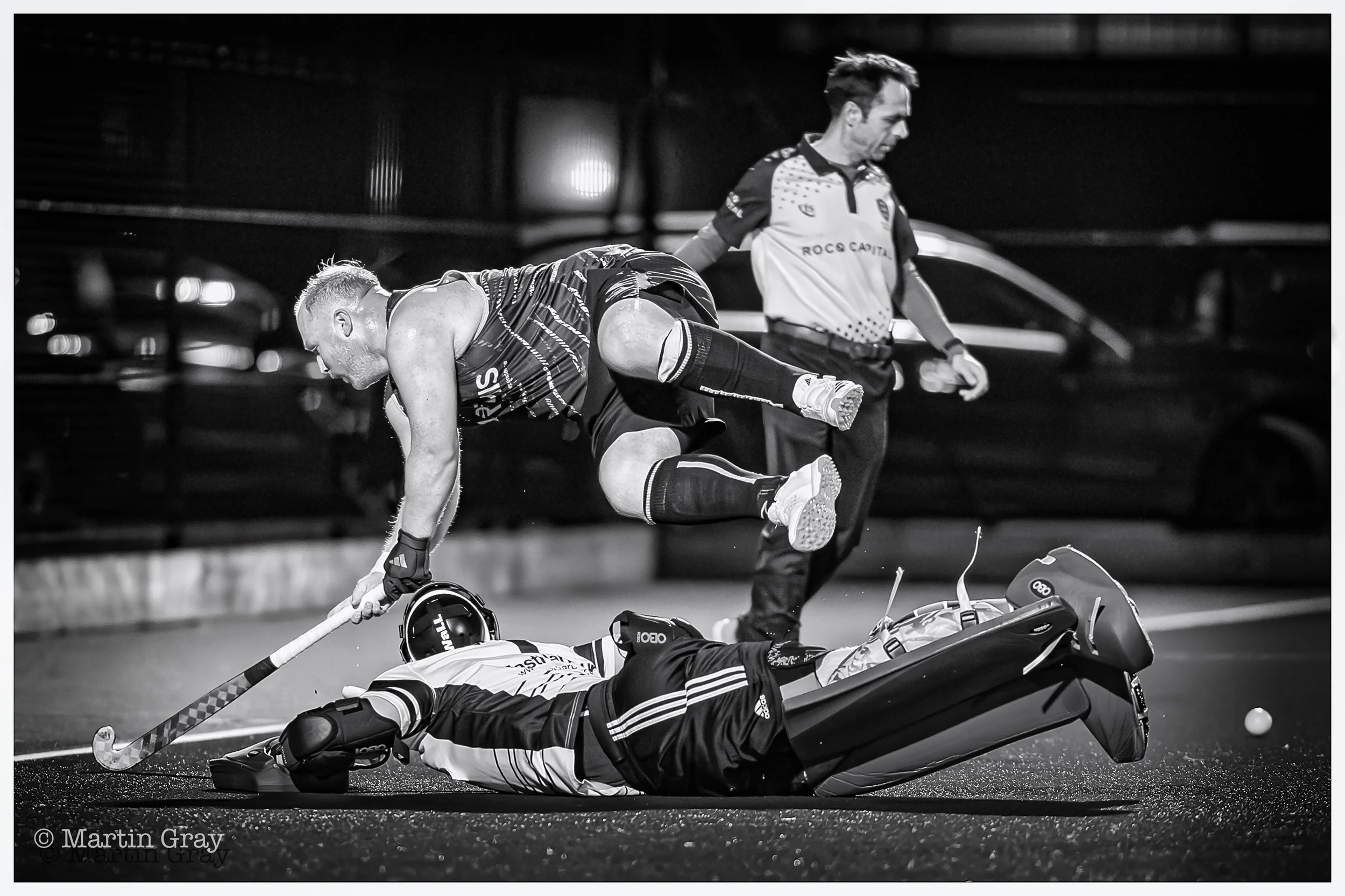 Louis Day saves as Alex Bushell takes flight as he attacks the College goal B+W-3.jpg