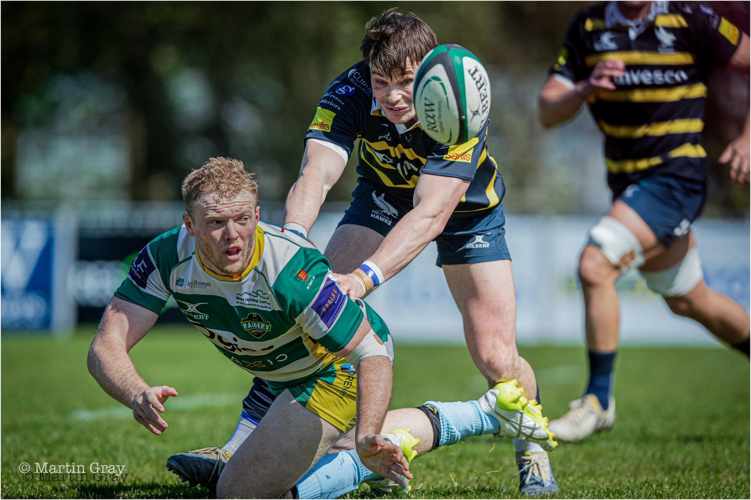 Ciaran McGann offloads a pass in tackle-7072.jpg