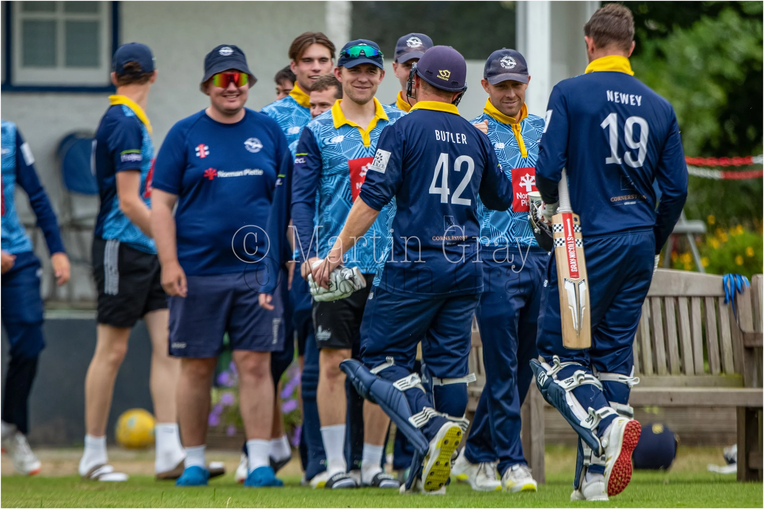 Josh Butler leaves the field 122 not out to be congratulated by teammates-6209.jpg