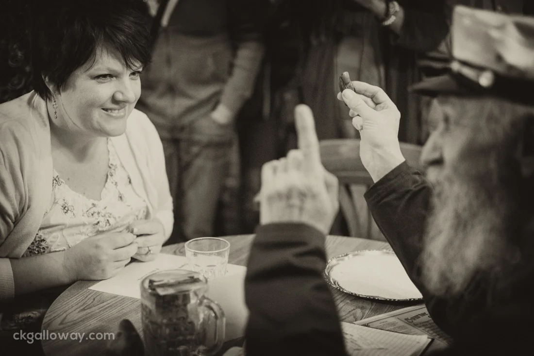 Dawson City visitor Joy Hinson gets the pre-sour toe spiel before taking her shot. Yes, that's a real toe. Photo by Christa Galloway.
