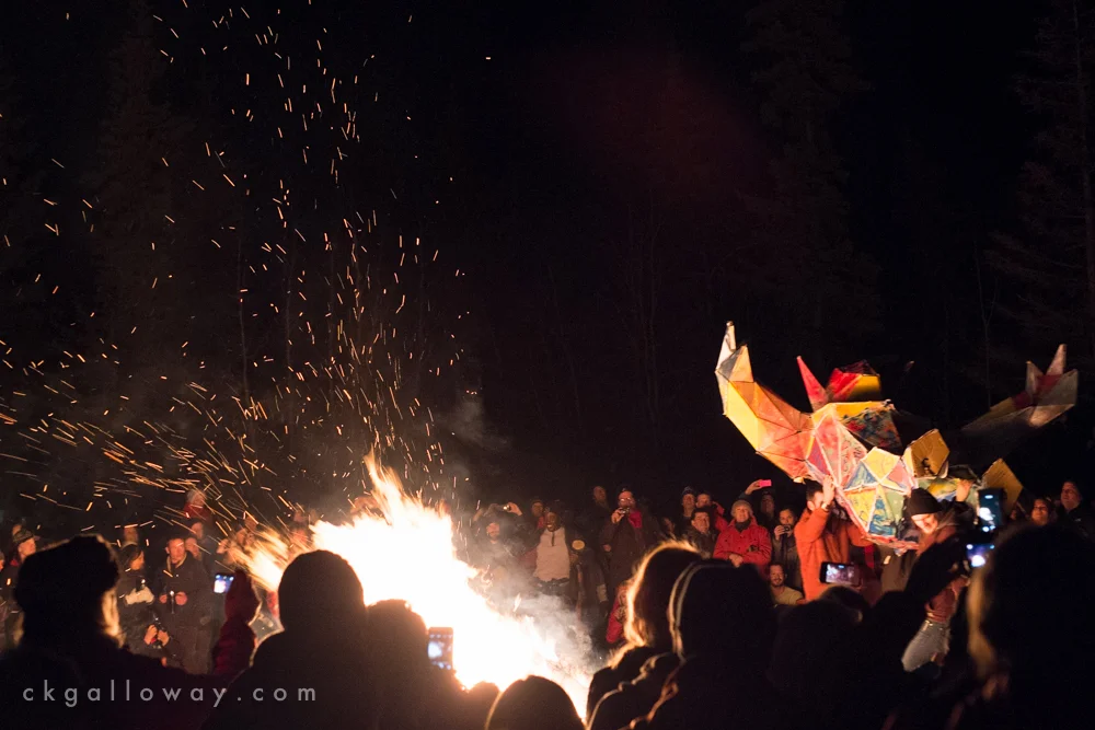 An effigy is thrown into a bonfire at the Burning away the Winter Blues event in Whitehorse, 2015. Photo by Christa Galloway.