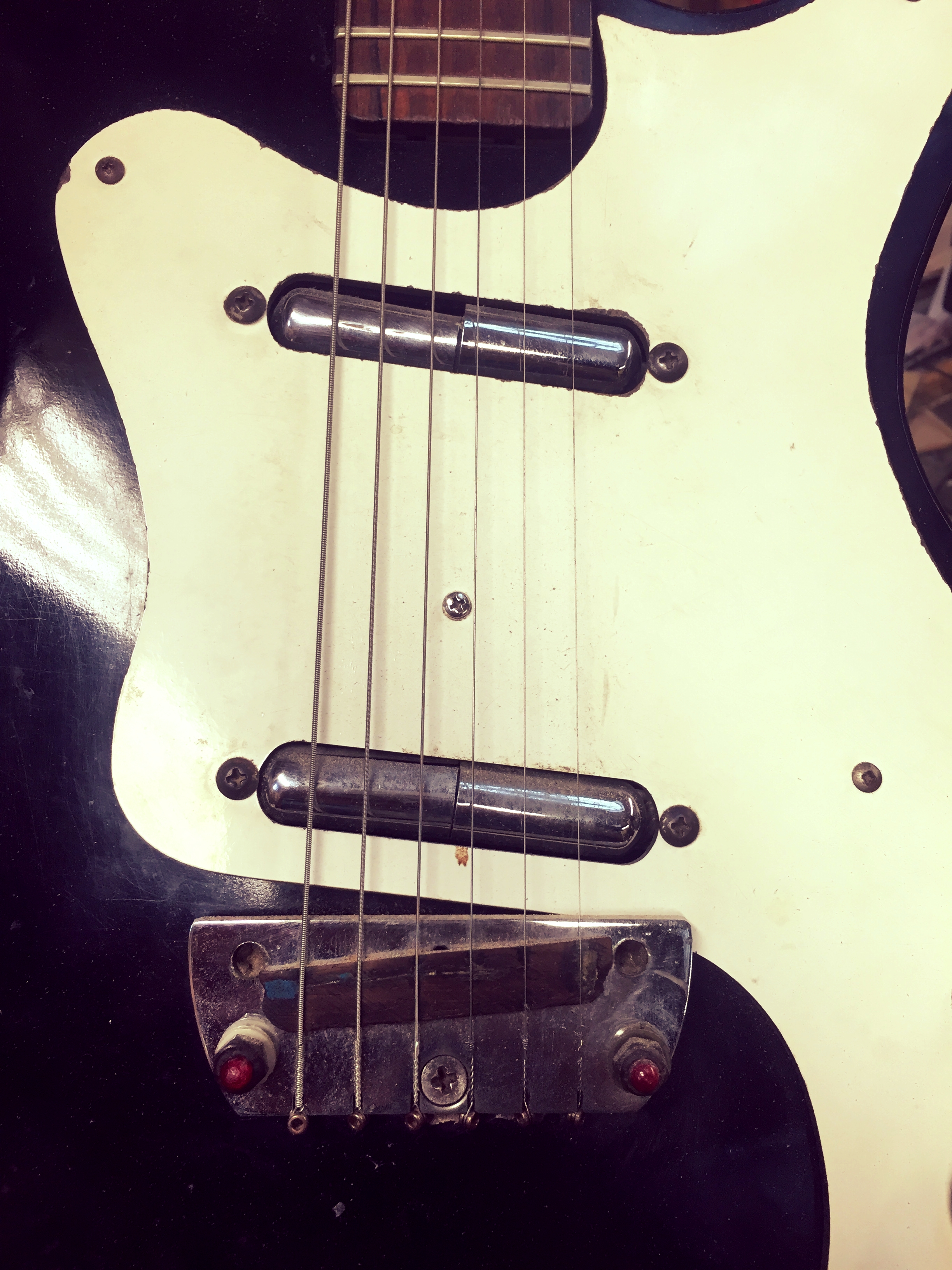 Top left: reclaimed wood piles all the way to the ceiling of the shop. Bottom left: guitar necks of all sorts and shapes. Right: detail of pick ups, they are lip stick tops, how creative and vintage school looking. Volume and tone knobs not pictured were recycled from old radios. Recycling is a matter of originality and imagination!