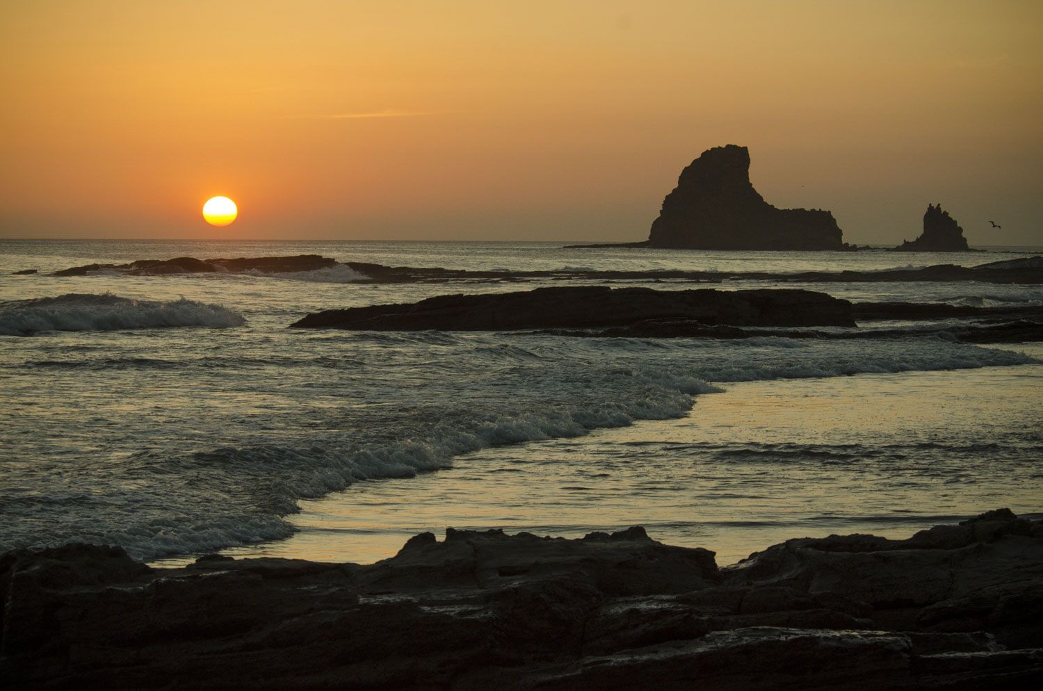 Shark fin rock standing tall at sunset