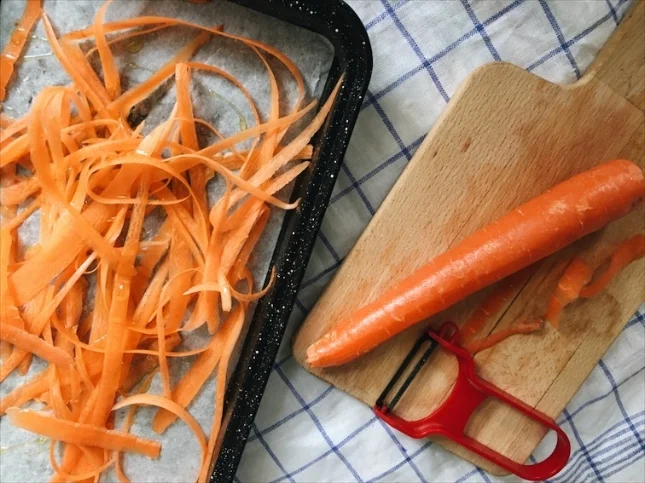 Skinning the carrots. 