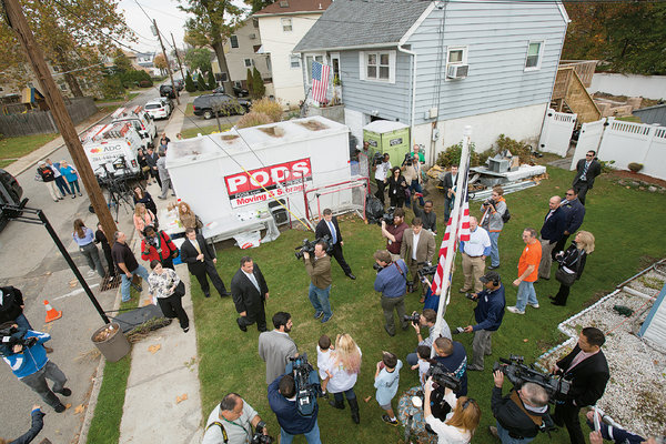 Governor Chris Christie surrounded by media and constituents after Sandy.