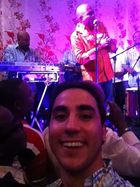 Dr Fernando Mariotto enjoys a performance by Haitian President Michel Martelly during a Carnival of Flowers party.
