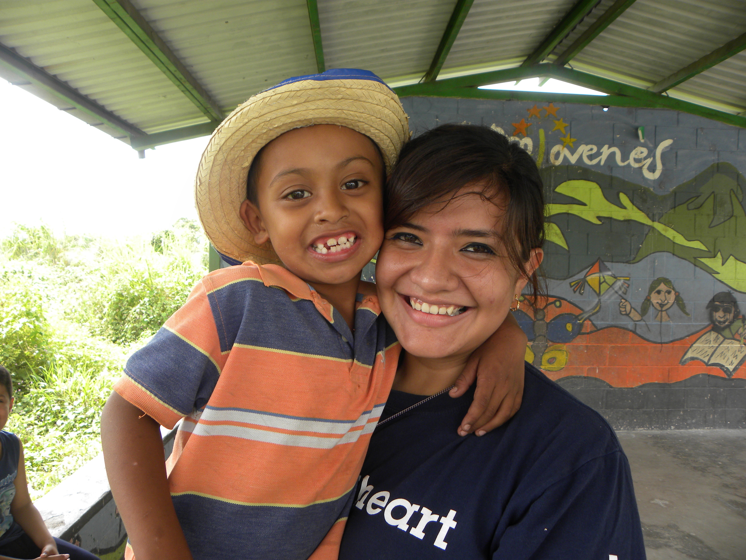 Wanda Bonderer and a boy from Chatarrera pose under the "sombra," a shaded area where the children can play.
