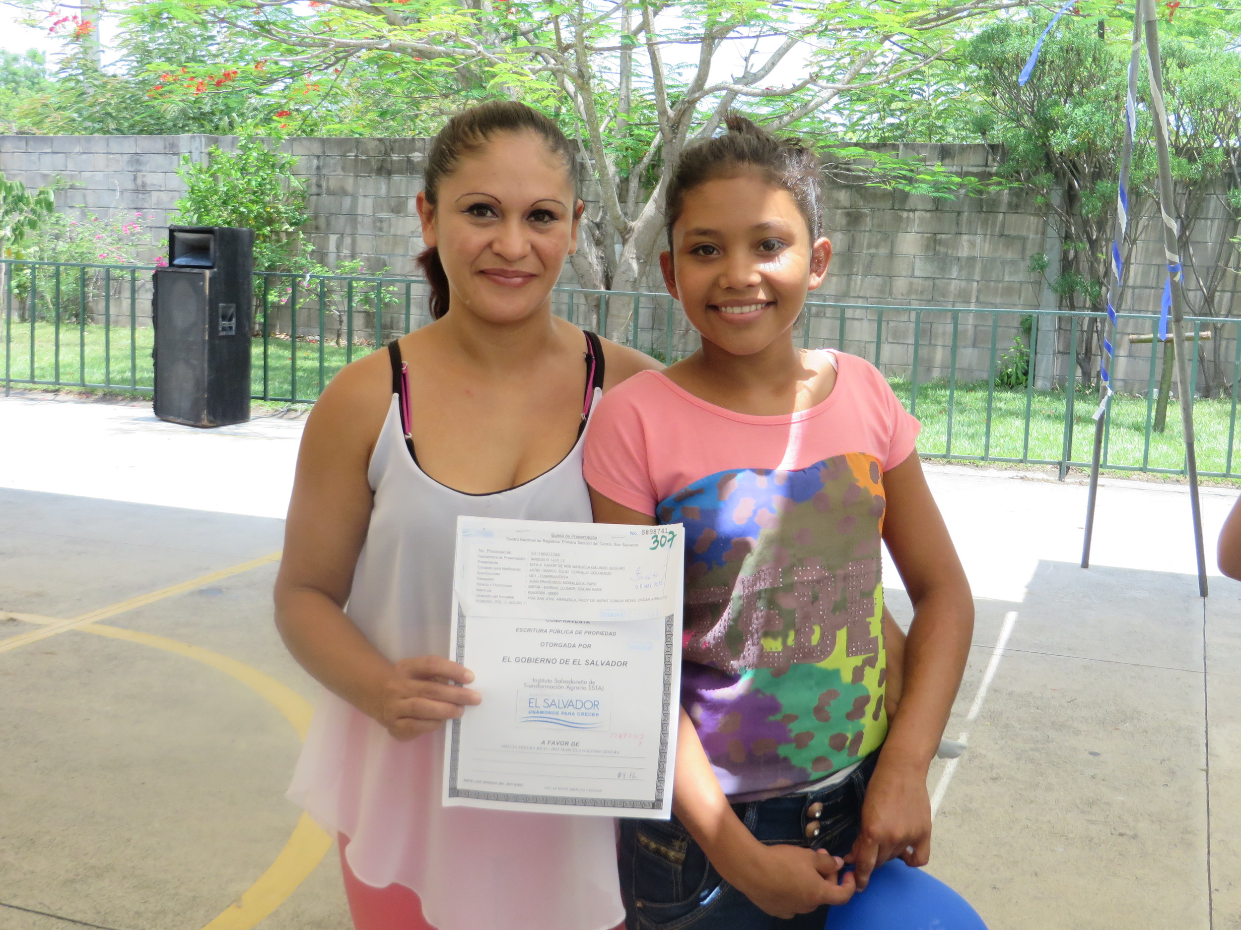 Romero Community residents proudly display the title to their land. See more pictures of The Romero Community.