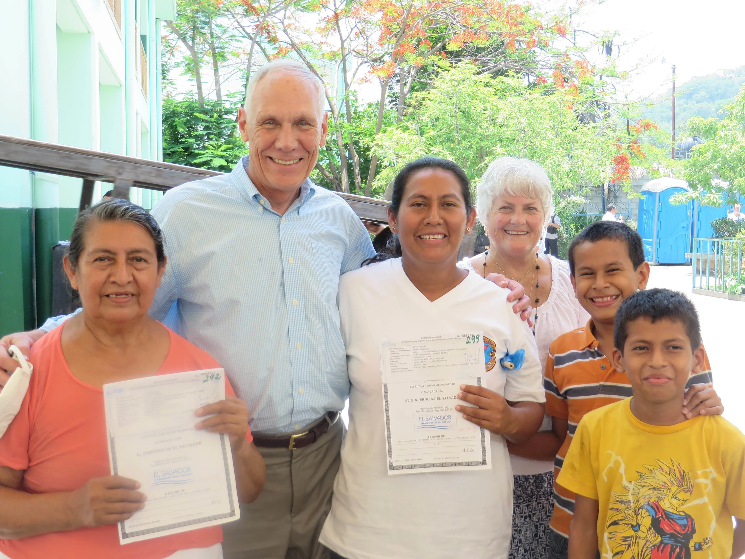 Community members proudly display their new land title.