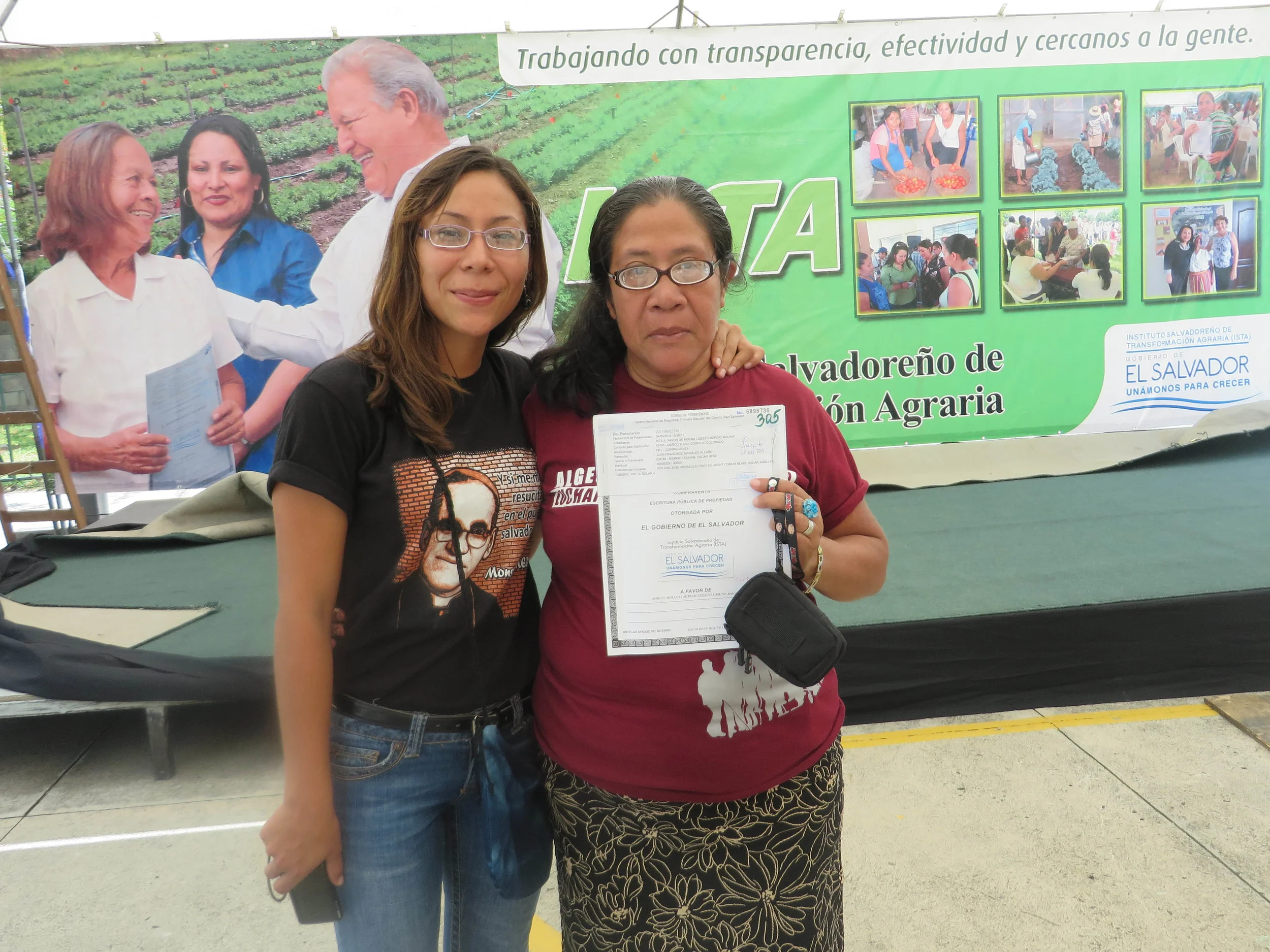 Community members proudly display their new land title.