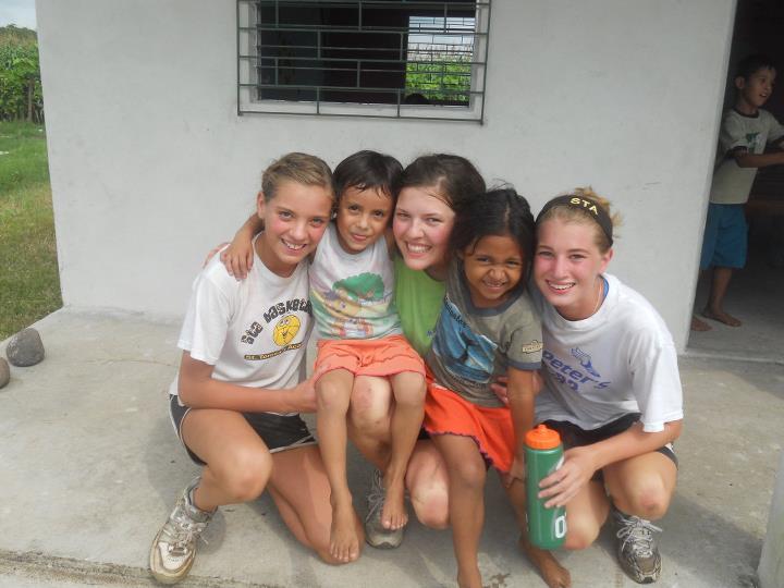 Siobhan, Shaughnessy, and Keara Miller with Salvadoran children during their family trip.